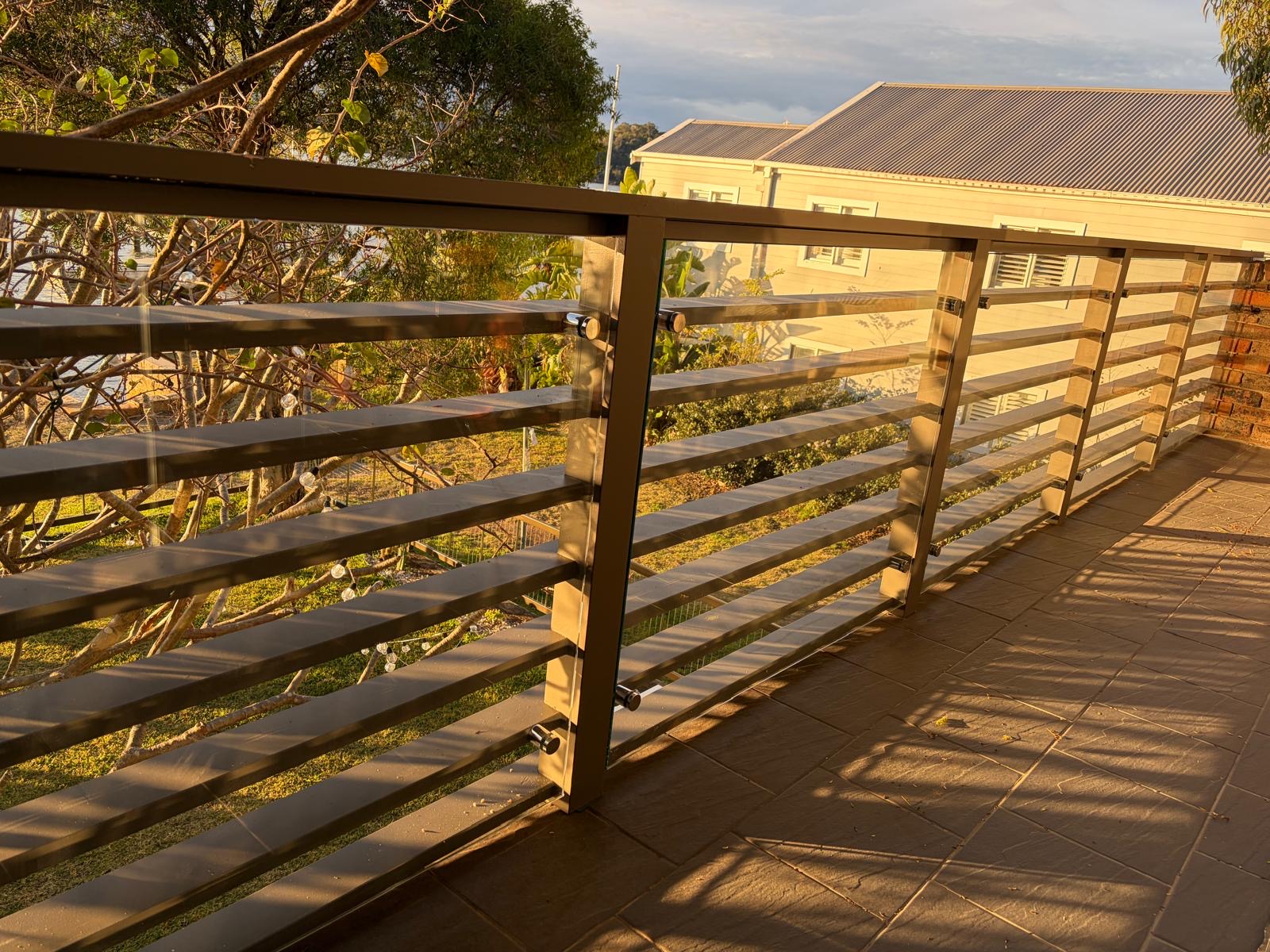 Steel and glass balustrade detail at sunset