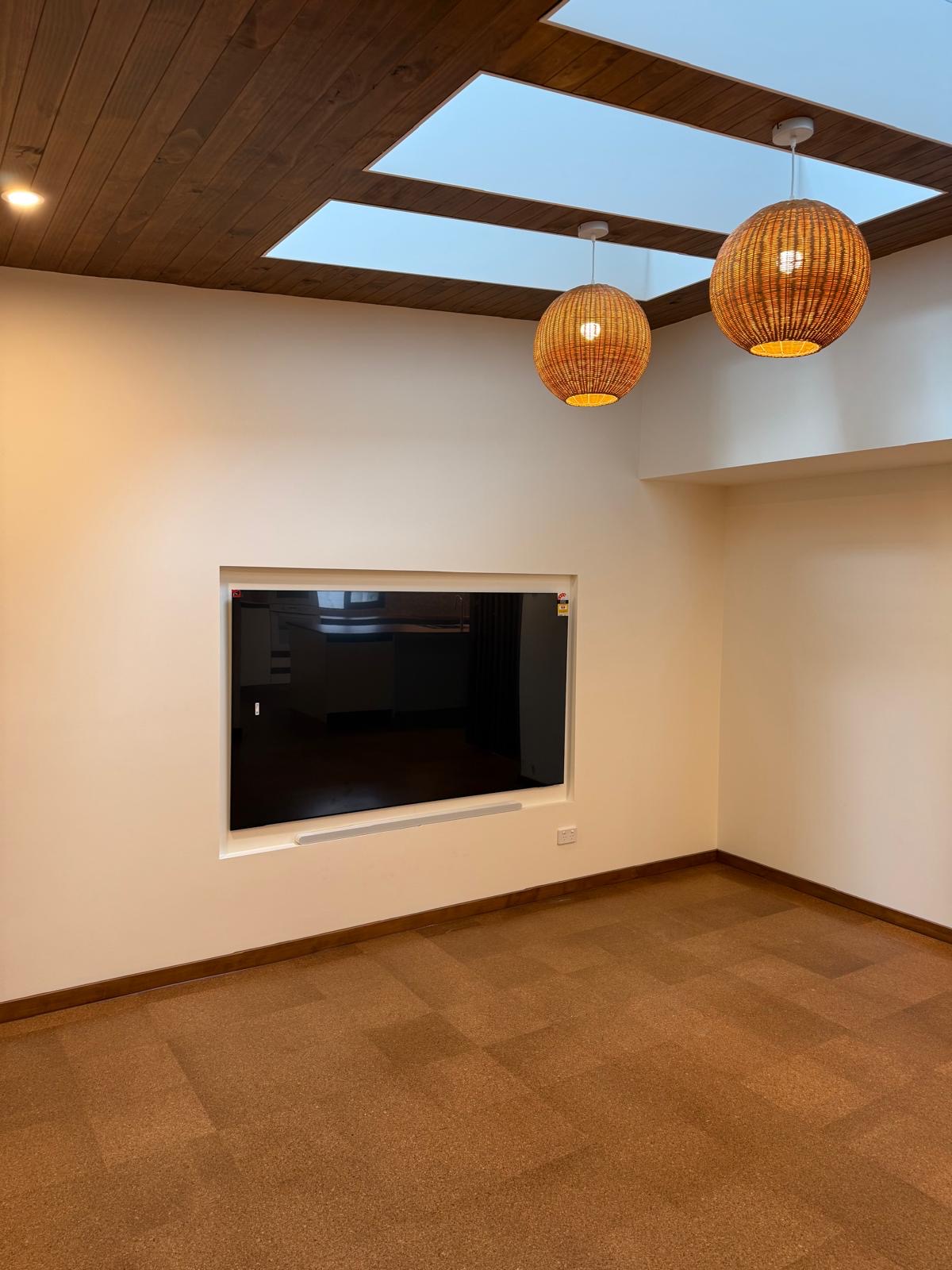 Living room with skylights and pendant lighting