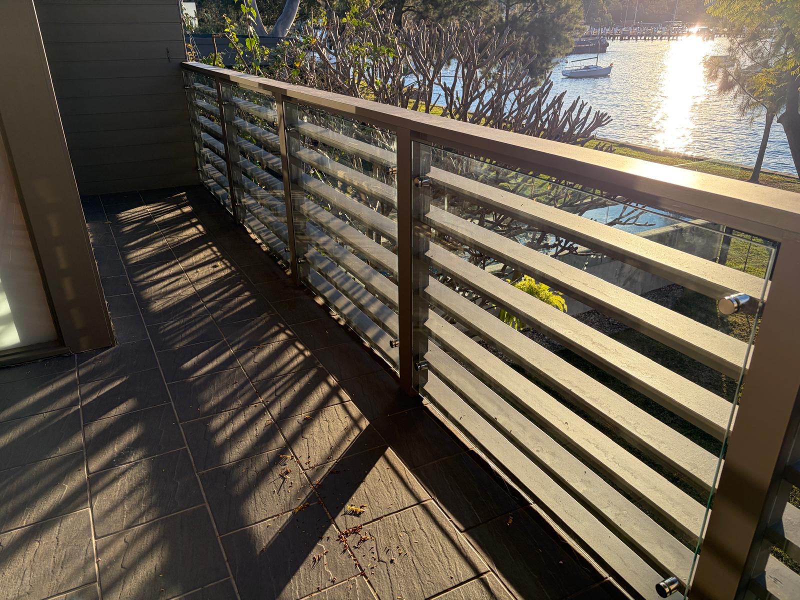 Balcony with glass and steel balustrade over the water