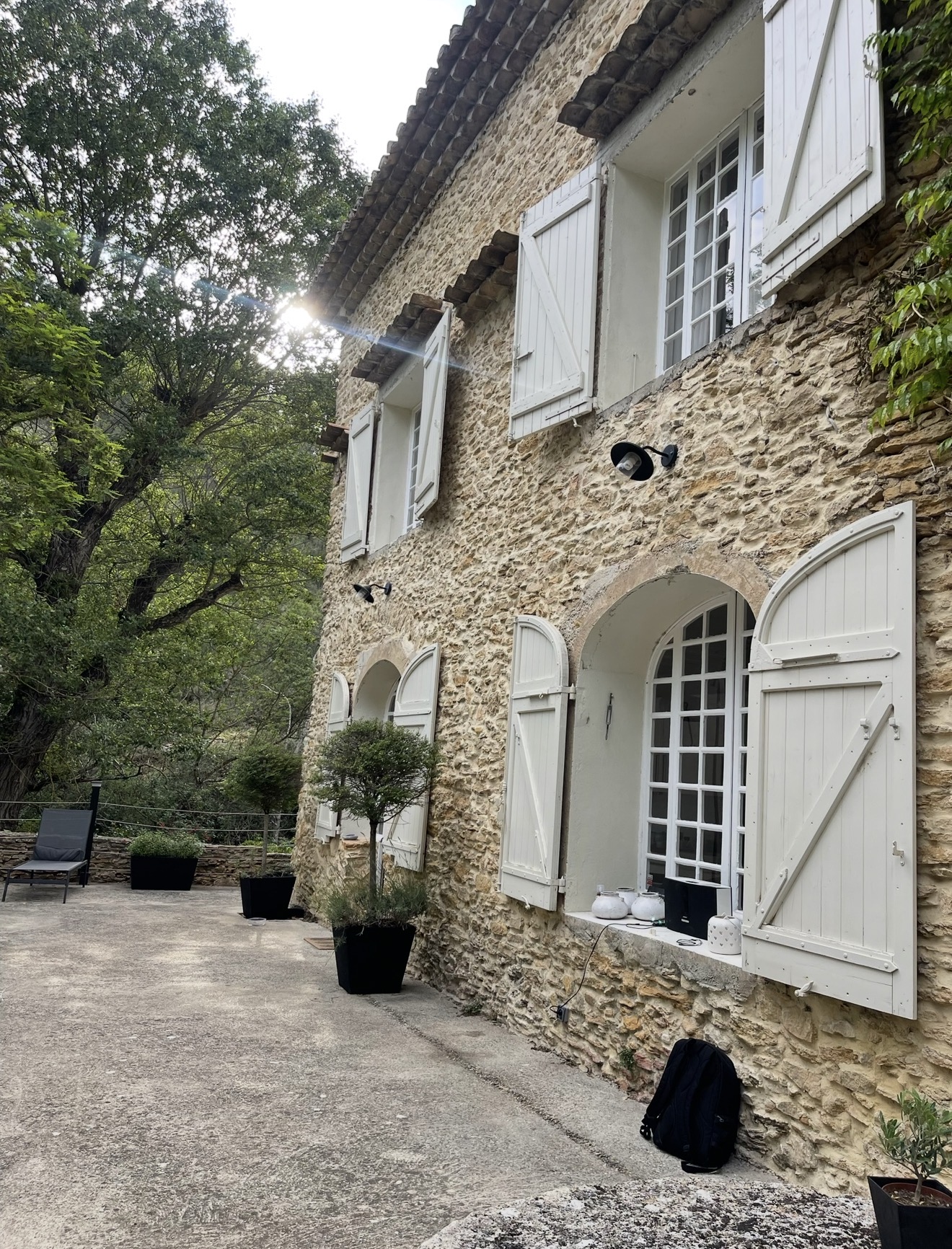 Arched windows and shutters along the mill house