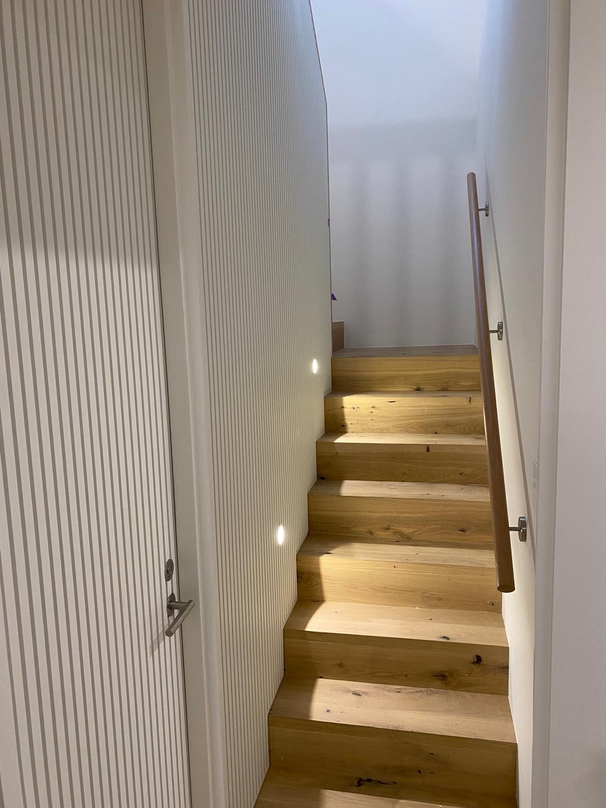 Oak stair with timber handrail and batten wall